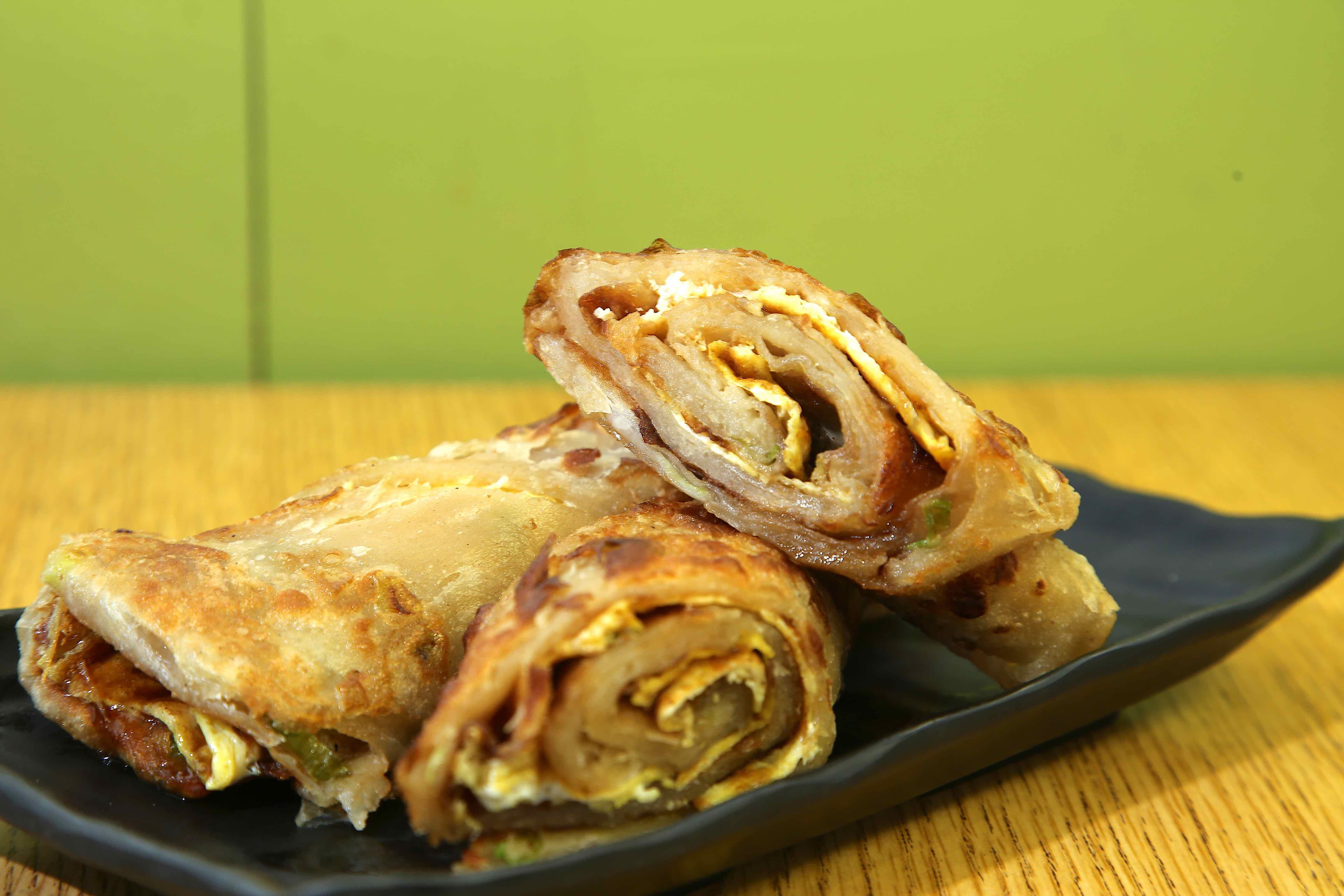 Green Onion Pancake with egg - Green onion pancake enhanced with a layer of scrambled egg. A flavorful combinat | Dim Sum